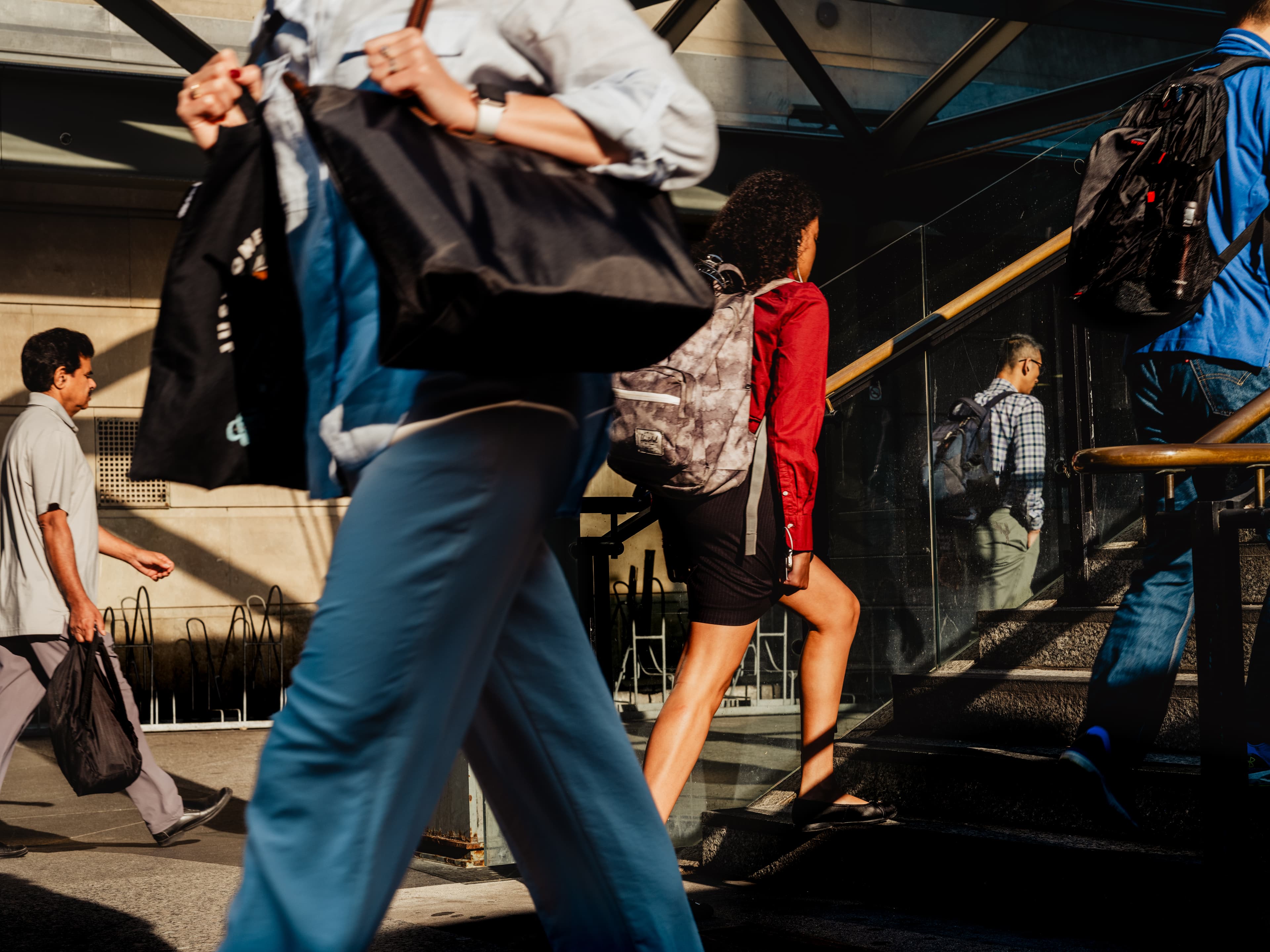 People walking up and around a flight of stairs in a hurry